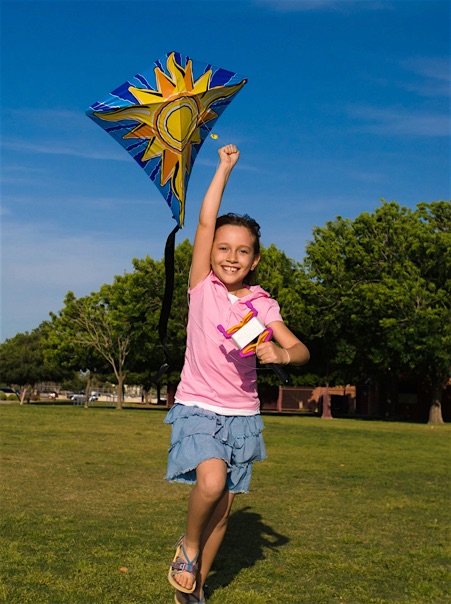 editorial photography young girl running with a kite